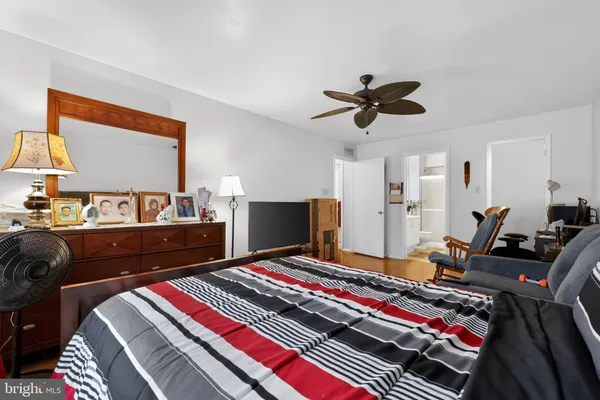 a bedroom with furniture and a flat screen tv