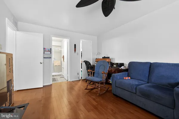 a living room with furniture gym equipment and a window