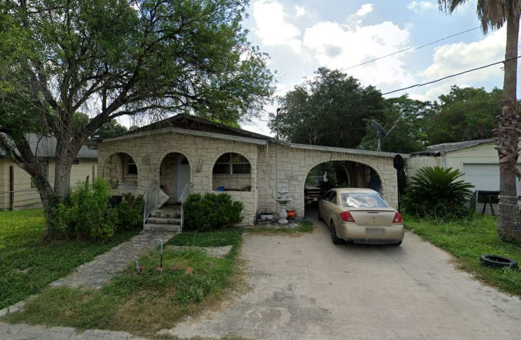 a car parked in front of white house