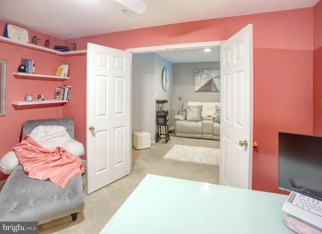 a living room with furniture and kitchen view
