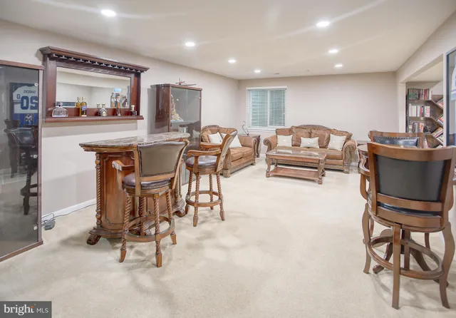 a living room with furniture ceiling fan and a rug