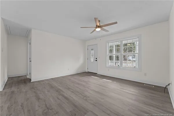 wooden floor in an empty room with a window