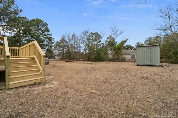 a view of house with deck and outdoor seating