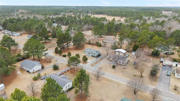 a view of a house with a backyard and garage