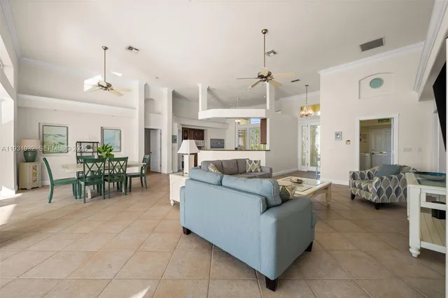 a kitchen with stainless steel appliances granite countertop a stove top oven a sink a dining table and chairs