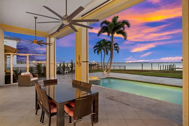 a view of swimming pool with a table and chairs