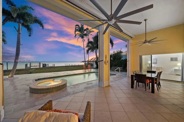 a view of a balcony with wooden floor and a ocean view