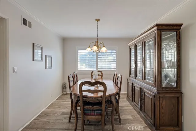 a dining room with furniture window and wooden floor