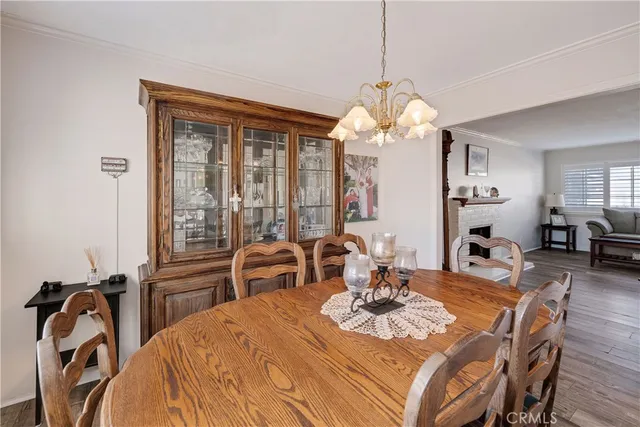 a view of a dining room with furniture and chandelier
