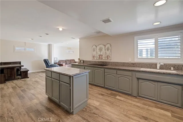 a kitchen with a stove sink and cabinets