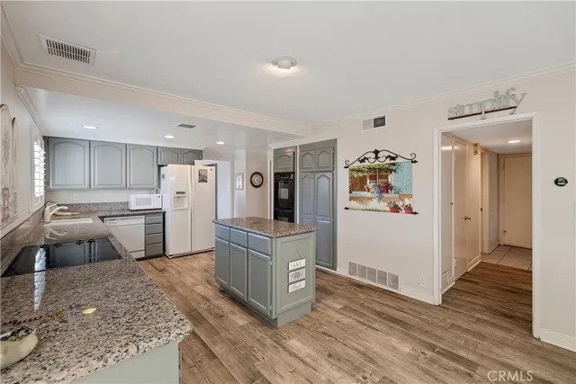 a large white kitchen with cabinets and stainless steel appliances