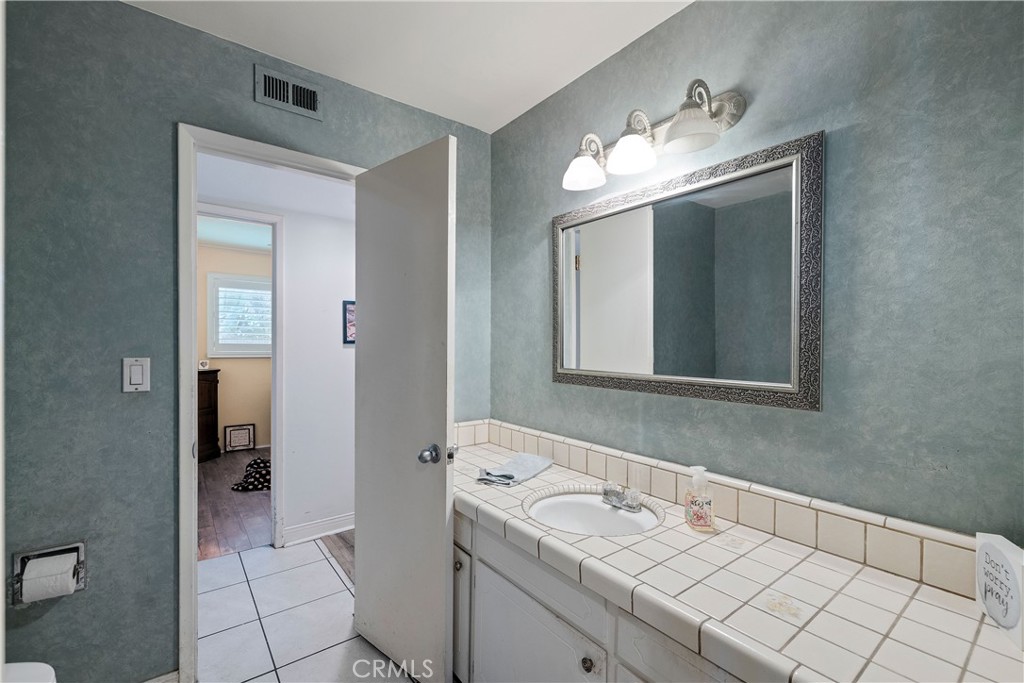 813 Statler Street San Pedro, CA 90731 - Photo 30 of 42 a bathroom with a sink and a mirror