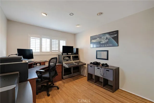 a view of a workspace with furniture and a window