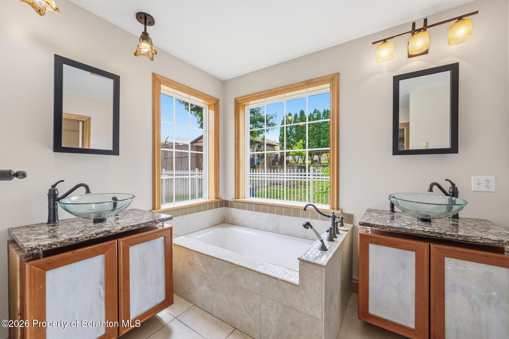 116 Forge Street Old Forge, PA 18518 - Photo 25 of 49 a bathroom with a granite countertop tub sink and mirror