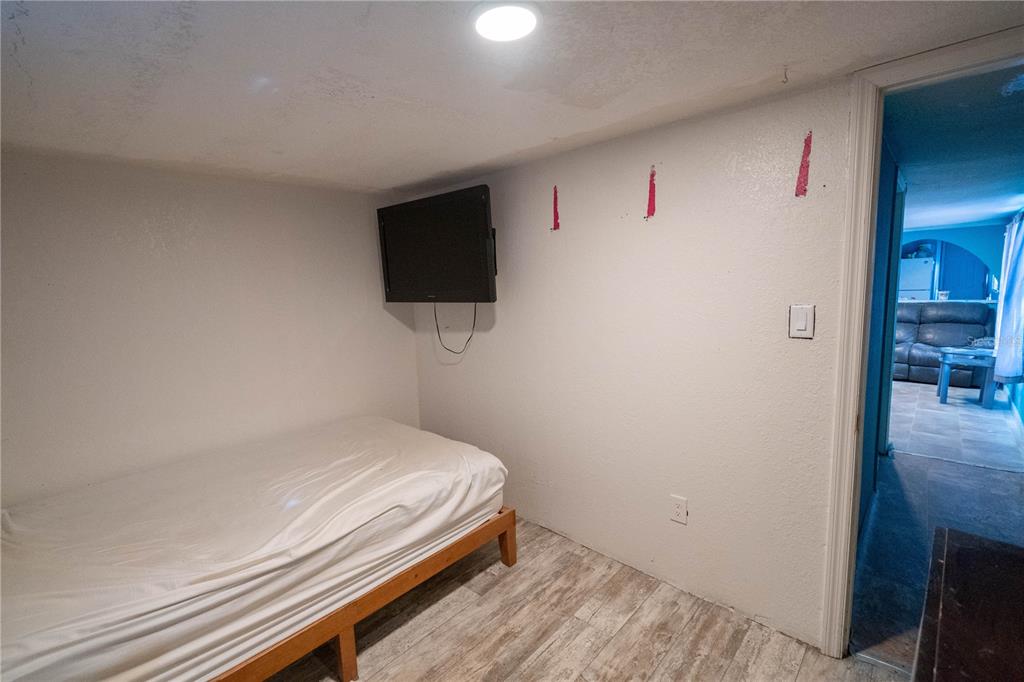 201 Maple Street Winter Haven, FL 33880 - Photo 13 of 16 a bedroom with a bed and a flat screen tv