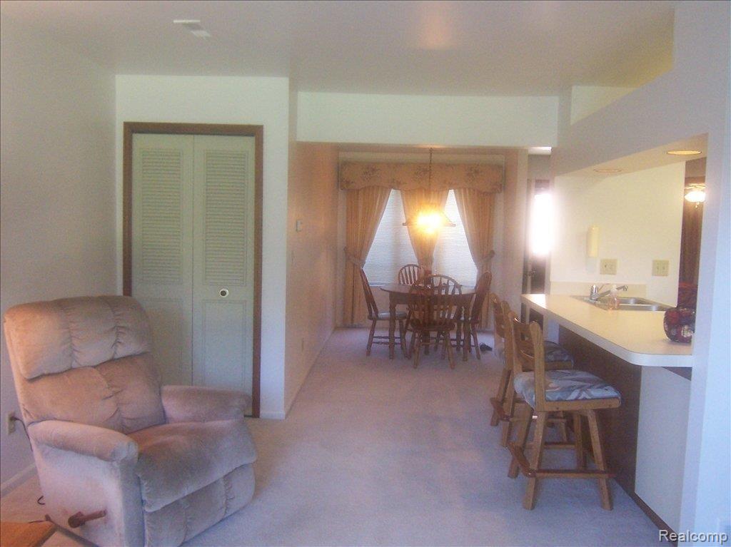 1553 Meadowside Drive, Unit 182 Rochester, MI 48307 - Photo 13 of 25 Living Rm to Dining Rm