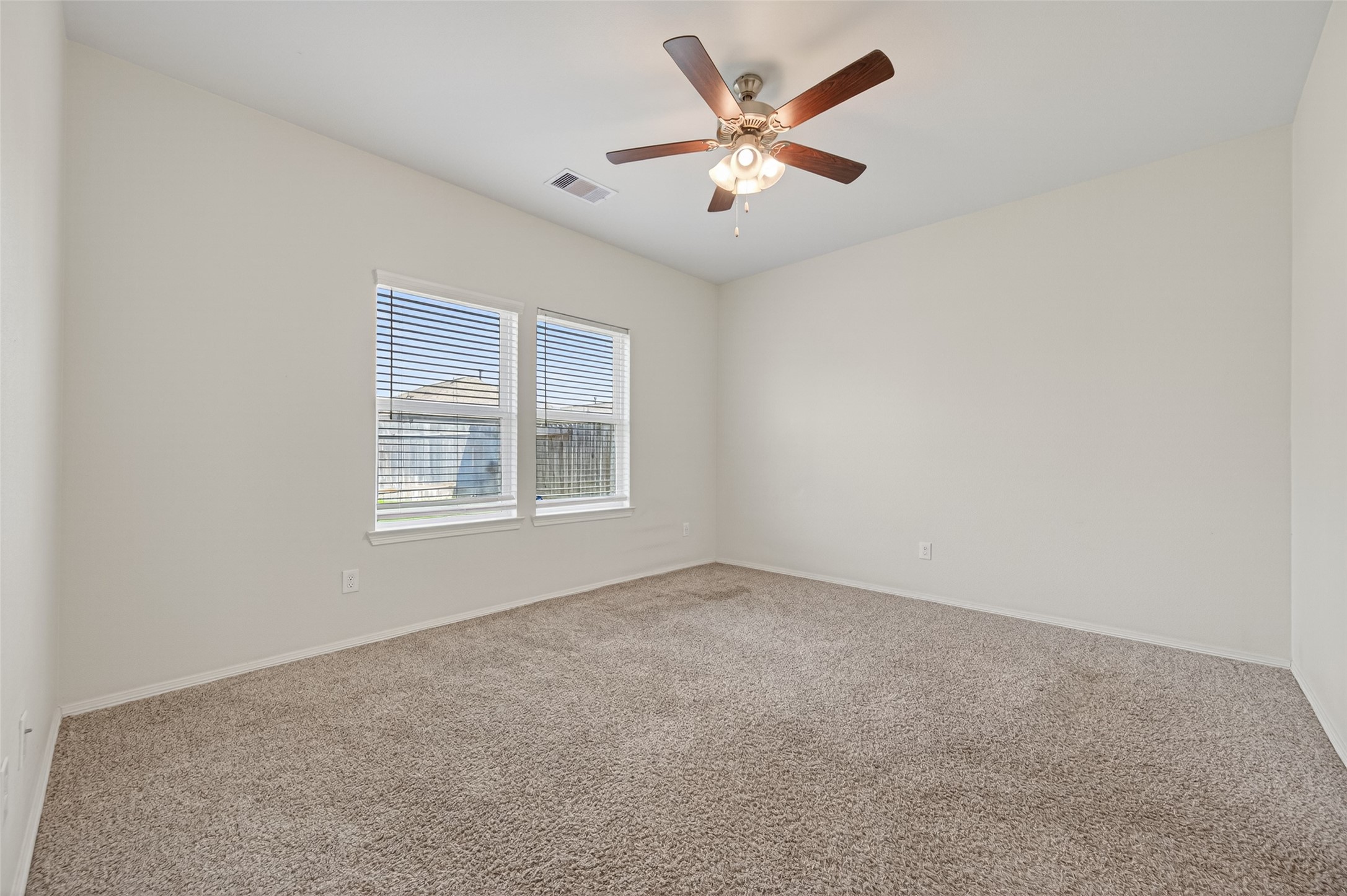 23222 Spring Genesis Lane Katy, TX 77493 - Photo 28 of 43 Spacious primary bedroom featuring expansive bay windows for abundant natural light.