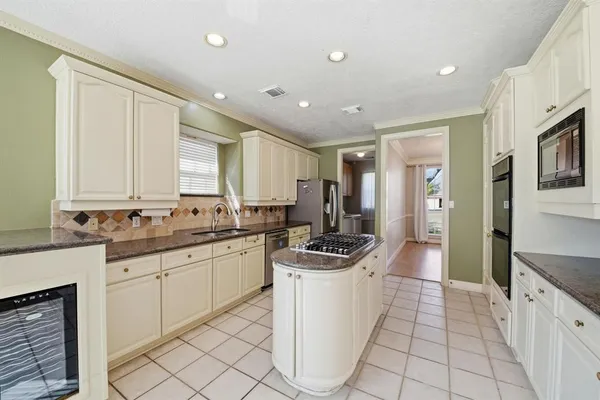 a kitchen with a sink stove and cabinets