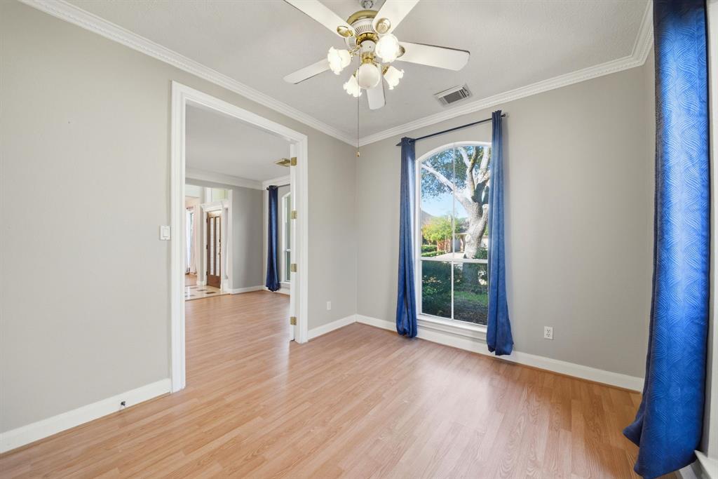 5315 Ridgewood Reef Houston, TX 77041 - Photo 15 of 35 a view of an empty room with window and wooden floor