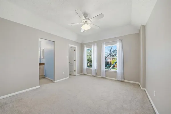 a view of a livingroom with a ceiling fan and window