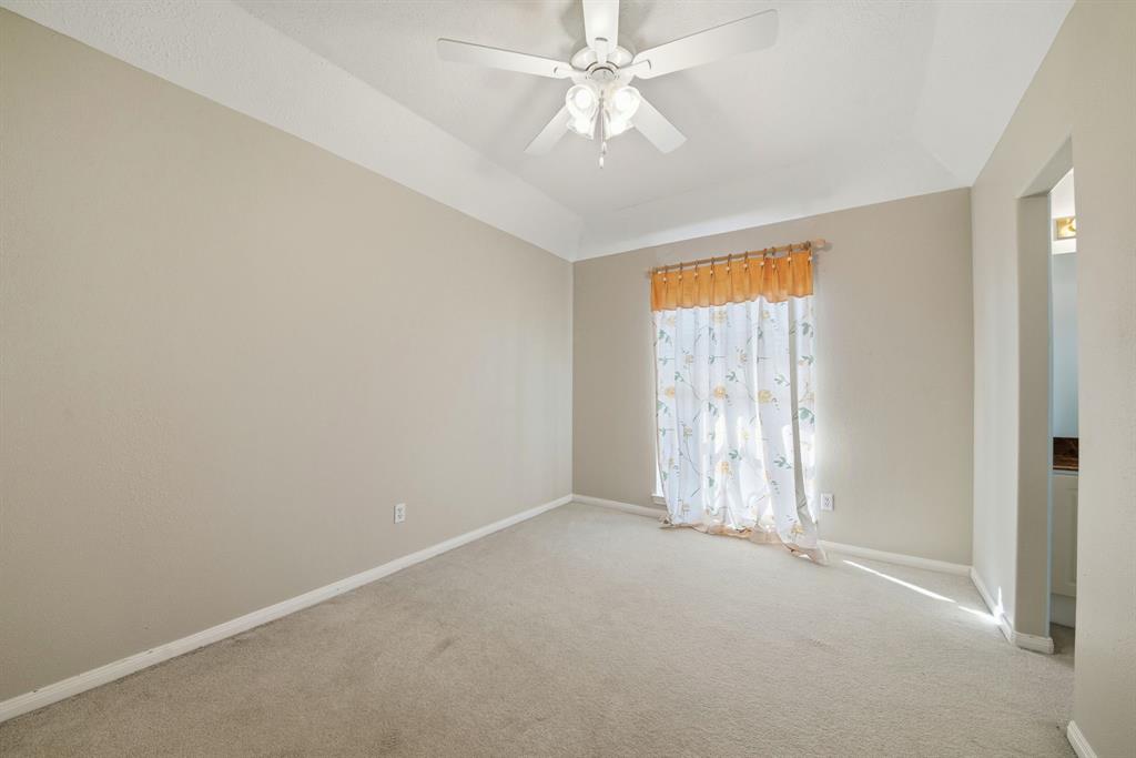 5315 Ridgewood Reef Houston, TX 77041 - Photo 20 of 35 an empty room with a chandelier fan and windows