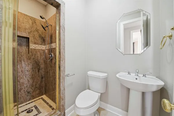 a bathroom with a toilet sink and shower