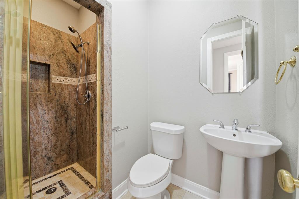 5315 Ridgewood Reef Houston, TX 77041 - Photo 21 of 35 a bathroom with a toilet sink and shower