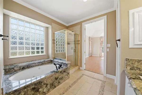 a bath tub sitting in a bathroom next to a window