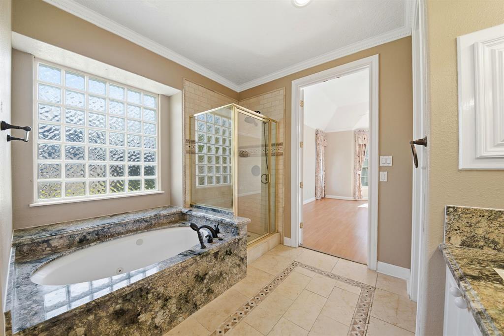 5315 Ridgewood Reef Houston, TX 77041 - Photo 23 of 35 a bath tub sitting in a bathroom next to a window