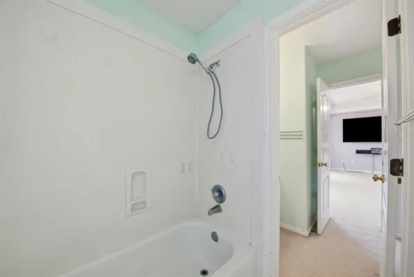 a bathroom with a bathtub and a shower