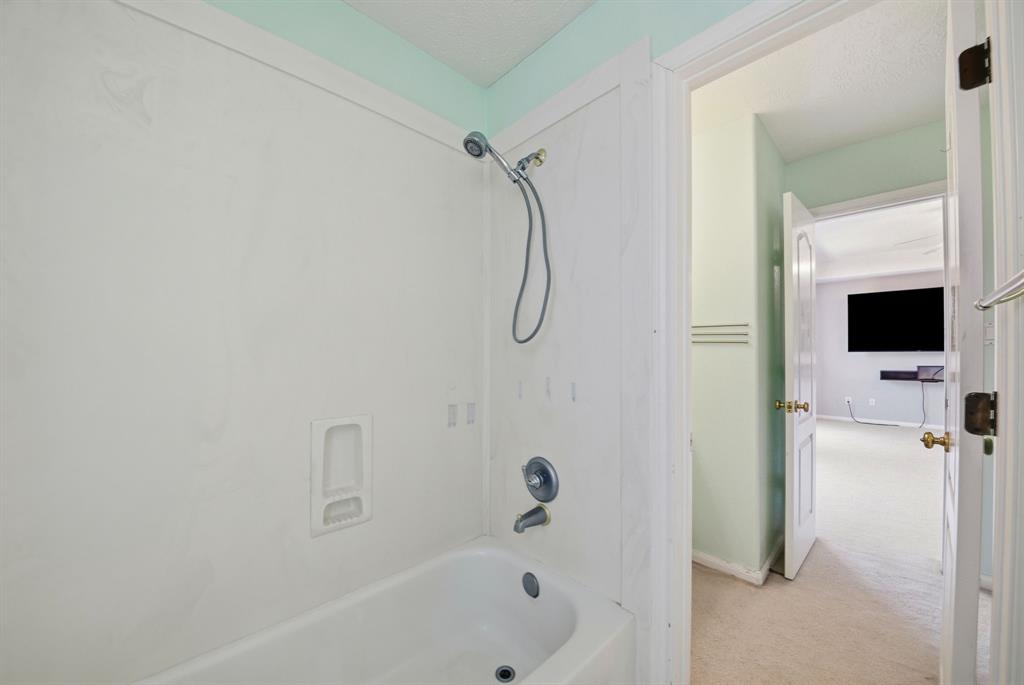 5315 Ridgewood Reef Houston, TX 77041 - Photo 25 of 35 a bathroom with a bathtub and a shower