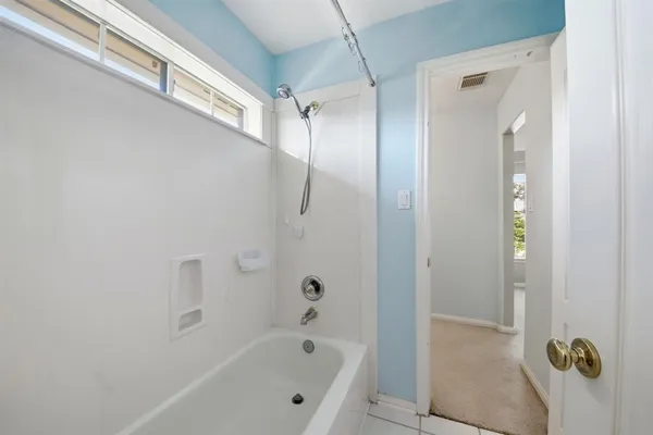 a bathroom with a tub and shower