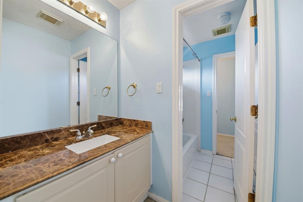 5315 Ridgewood Reef Houston, TX 77041 - Photo 28 of 35 a bathroom with a granite countertop sink and a mirror