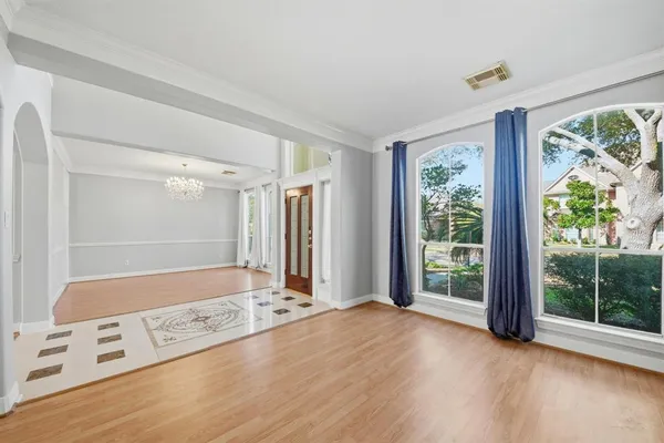 a view of a bedroom with furniture and window