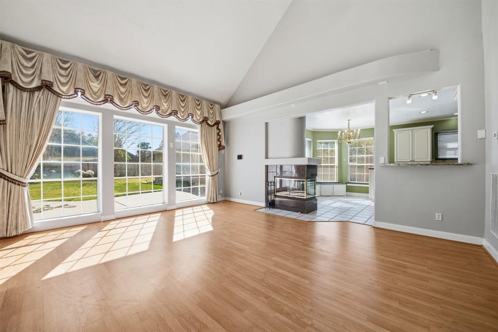 5315 Ridgewood Reef Houston, TX 77041 - Photo 9 of 35 a view of an empty room with wooden floor and a window