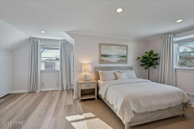 a bedroom with a large bed and a window