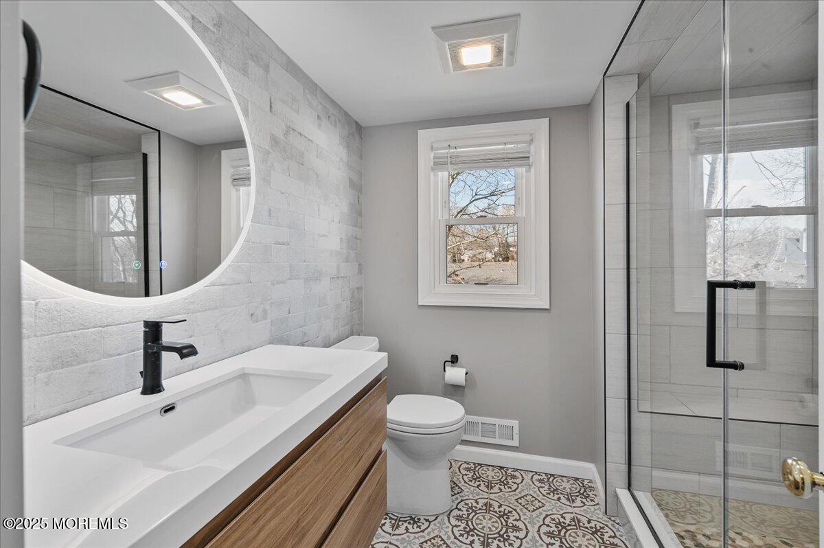 525 Riverwood Avenue Point Pleasant, NJ 08742 - Photo 19 of 30 a bathroom with a toilet sink and mirror