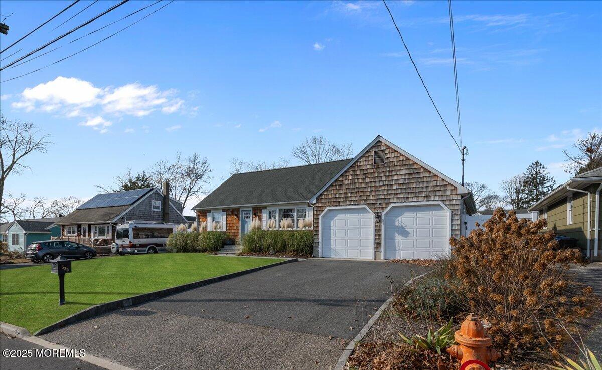525 Riverwood Avenue Point Pleasant, NJ 08742 - Photo 2 of 30 a front view of a house with a yard and garage