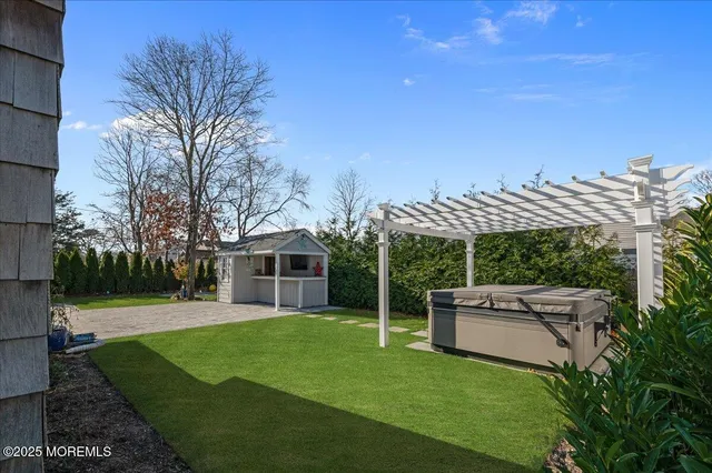 a view of a house with a backyard and a tree