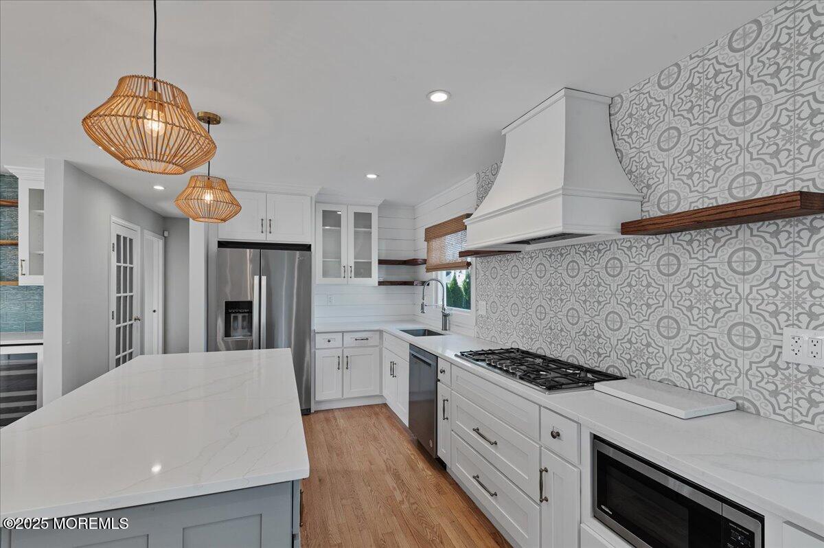 525 Riverwood Avenue Point Pleasant, NJ 08742 - Photo 7 of 30 a kitchen with stainless steel appliances granite countertop a sink a stove a refrigerator and cabinets