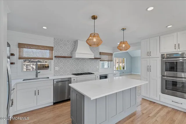 a kitchen that has a lot of cabinets and appliances