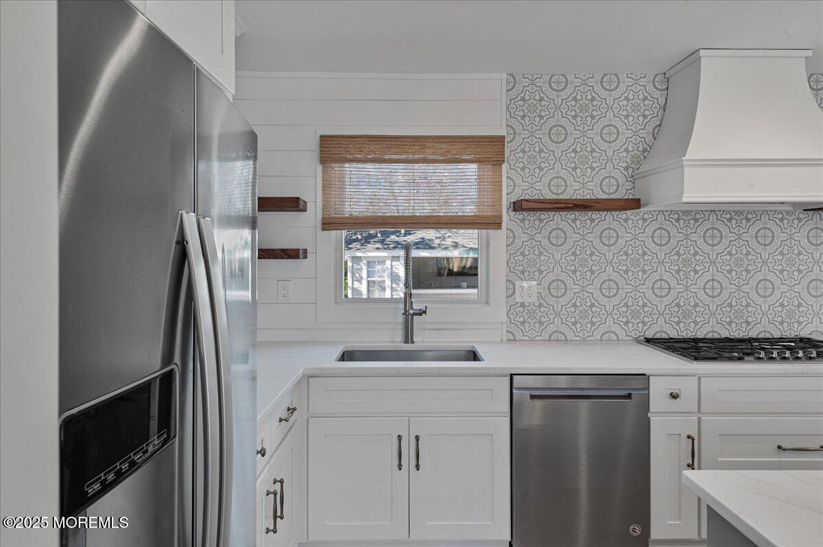 525 Riverwood Avenue Point Pleasant, NJ 08742 - Photo 9 of 30 a kitchen with a sink and a refrigerator