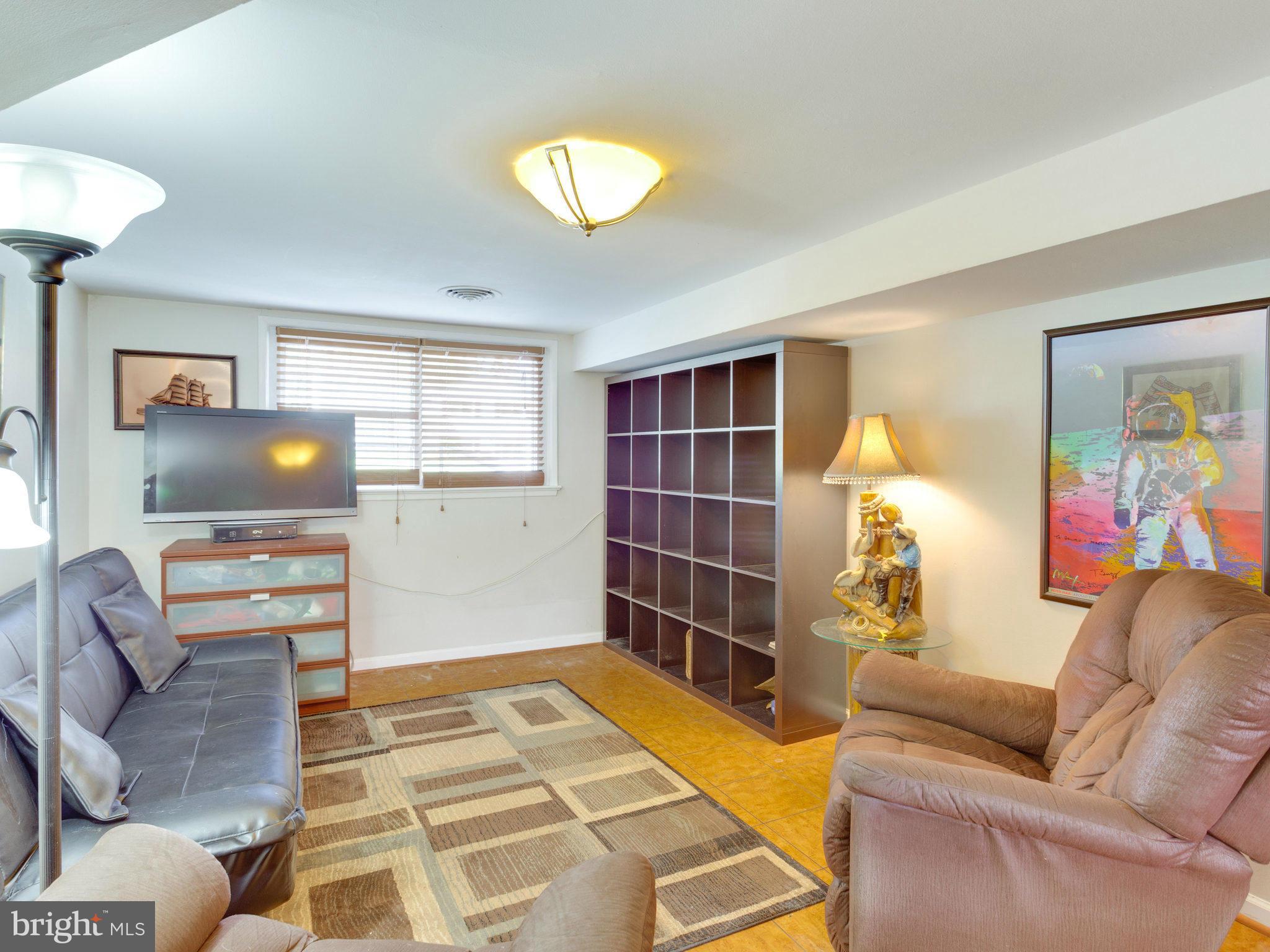 7528 June Street Springfield, VA 22150 - Photo 22 of 30 a living room with furniture and a flat screen tv