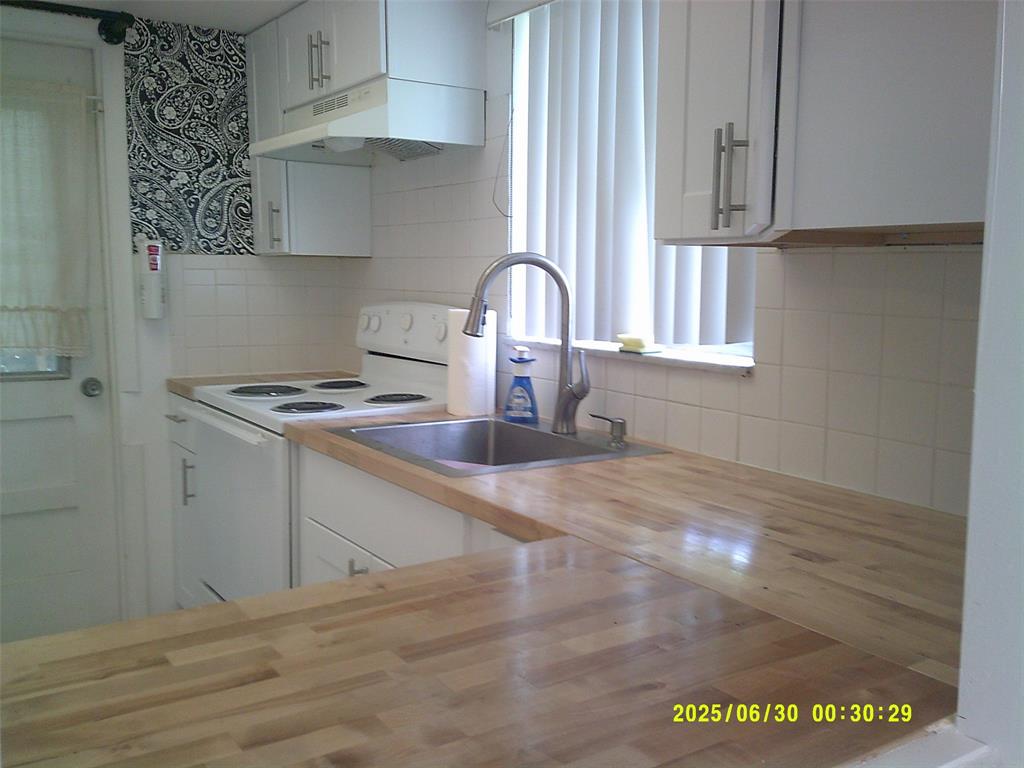 5800 Margate Boulevard, Unit 411 Pompano Beach, FL 33063 - Photo 16 of 30 a kitchen with stainless steel appliances granite countertop a sink a stove and a wooden floors