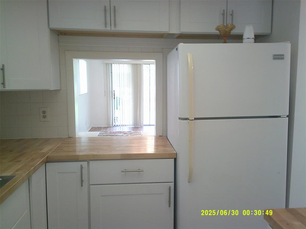 5800 Margate Boulevard, Unit 411 Pompano Beach, FL 33063 - Photo 18 of 30 a view of a refrigerator in kitchen and cabinets