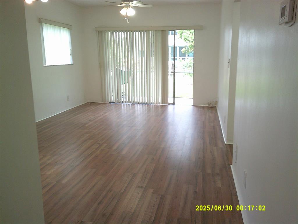 5800 Margate Boulevard, Unit 411 Pompano Beach, FL 33063 - Photo 2 of 30 wooden floor in an empty room with a window
