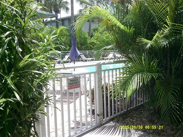 a view of a swimming pool with a patio and a garden