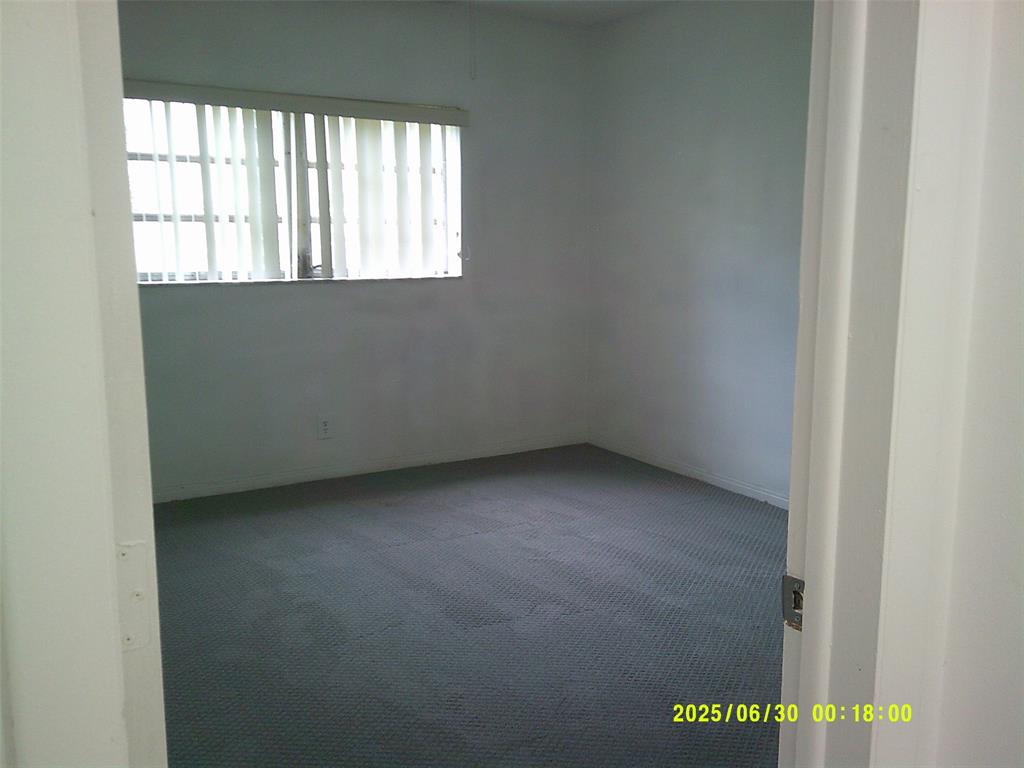 5800 Margate Boulevard, Unit 411 Pompano Beach, FL 33063 - Photo 5 of 30 an empty room with a window