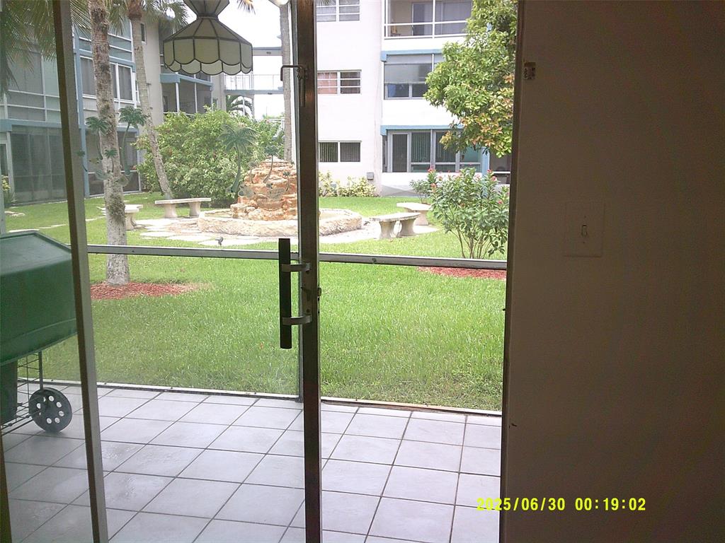 5800 Margate Boulevard, Unit 411 Pompano Beach, FL 33063 - Photo 7 of 30 a view of a porch and a yard