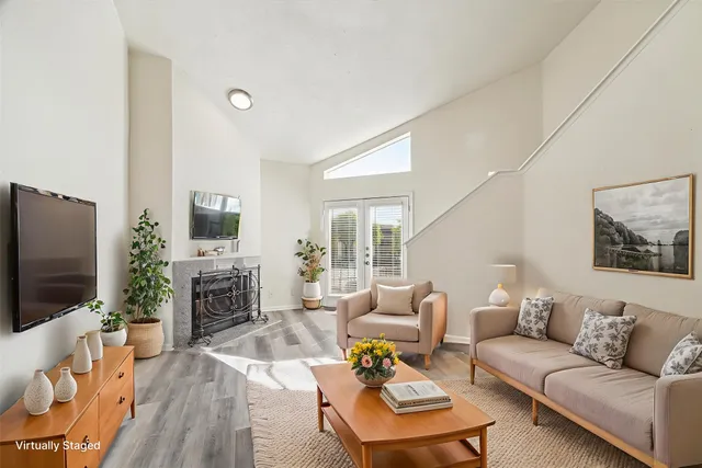 a living room with furniture a fireplace and a flat screen tv
